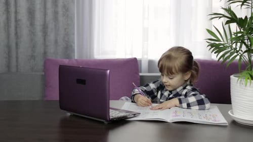 Girl Doing Homework at Home at Desk