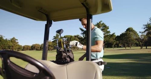 Male golfer removing golf club from golf bag