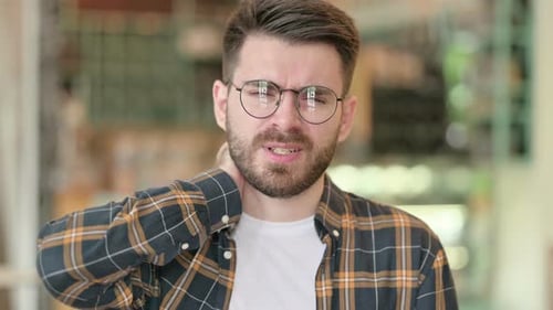 Young Adult Man Experiencing Neck Pain