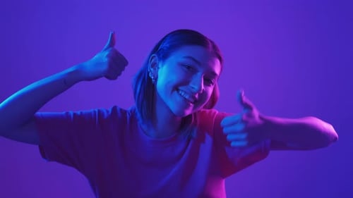 Woman Smiles and Gives Two Thumbs Up