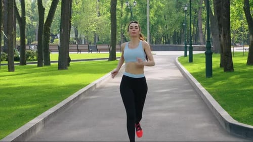Woman with Piercing Jogging in Park in Slow Motion