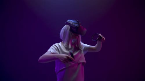 Woman Experiencing Virtual Reality with Headset and Controllers