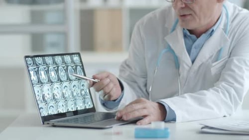 Doctor Explains Scan Results to Patient in Office