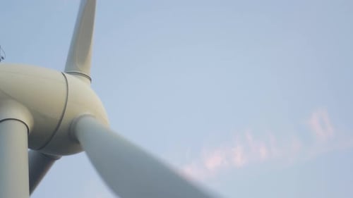 Close up windmill spins in slow wind