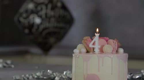 Festive Fourth Birthday Cake with Candle and Confetti