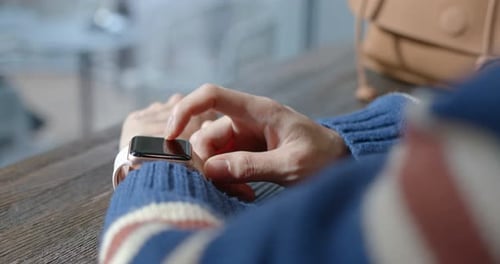 Woman use of smart watch in coffee shop