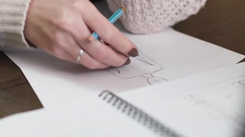Woman Sketching a Fashion Design with Pencil