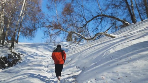 Man Running at the Mountain with Snow