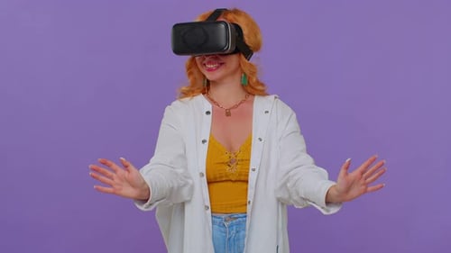 Woman Uses Virtual Reality Headset with Enthusiasm