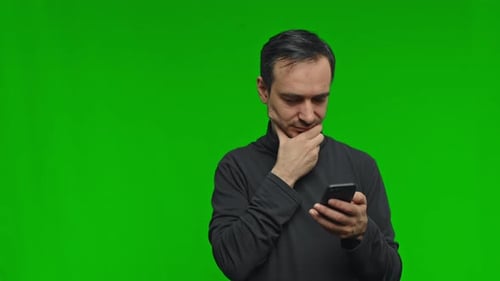 Man with Smartphone on Green Screen Background