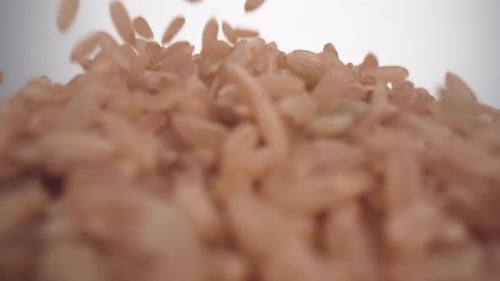 Pouring Light Brown Rice Accumulates into a Pile
