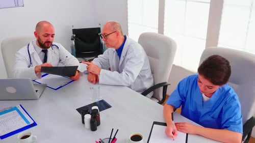 Medical Team Discussing X-ray in Conference Room