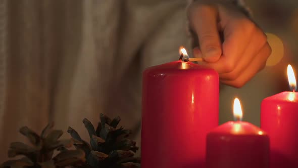 Girl Lighting Candle, Looking at Flame, Concept of Fire Safety at Christmas
