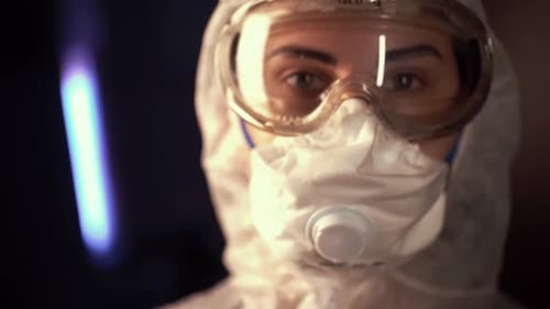 Person in Protective Suit, Mask, and Goggles