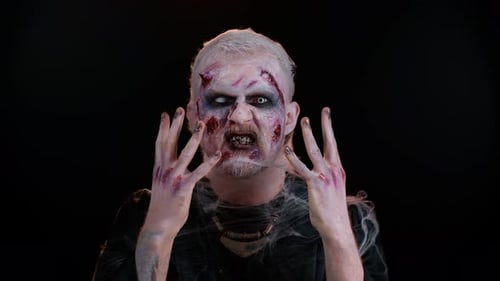 Theatrical Zombie with Makeup Against Black Backdrop