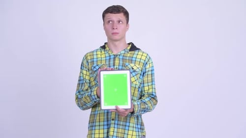 Young Adult Holds Up Tablet With Green Screen