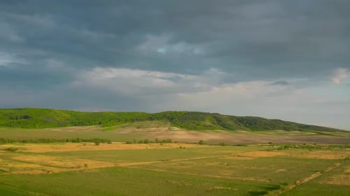 Flying Over Fields and Meadows, Green Hills on the Background