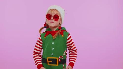 Excited Girl Dancing in Elf Costume for Christmas