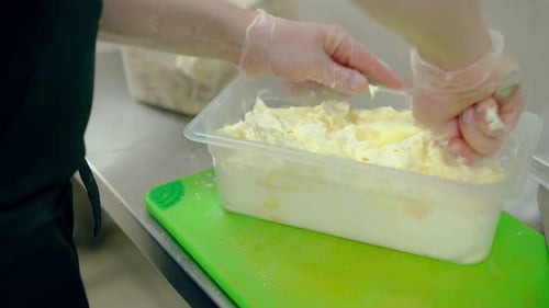Gloved Hands Mixing Cream in Commercial Kitchen