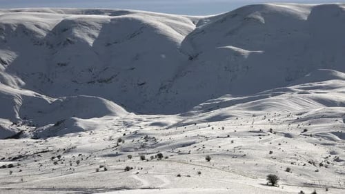 Snowy Mountain Ranges in Sunny Winter Day