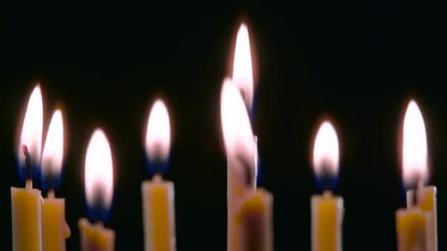 Candles Are Burning in the Spacious Room and Go Out. Black Background. Close Up