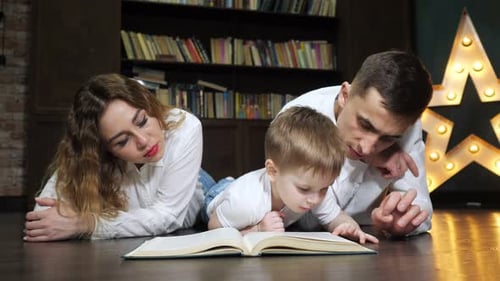 Family Reading a Book Together at Home