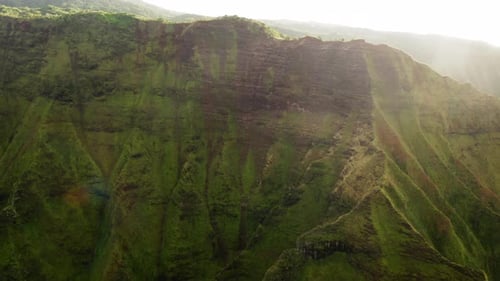 Scenic Aerial Footage of Wide Steep Slope of Volcanic Mountain Ravine Lit By the Sun