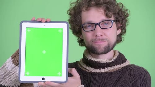Young Adult Holding Tablet With Green Screen