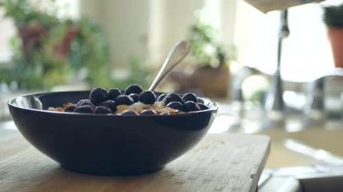 Milk Poured Over Cereal with Blueberries in Bowl