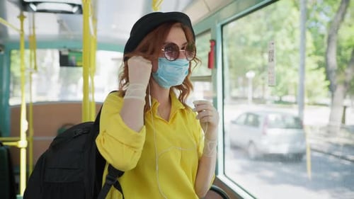 Woman with Face Mask Rides Public Transportation