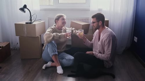 Happy Couple Relaxes After Moving in a New Home