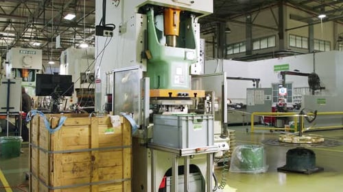 A large industrial punch press forming high precision metal parts for the automotive industry