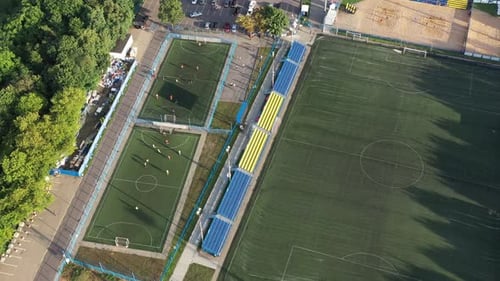 Top View of a Sports Football Field with Players Playing Football