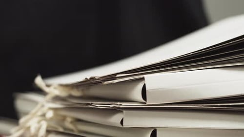 Stacking Folders with Documents in a Stack with Hands Counting Files Searching for the Right