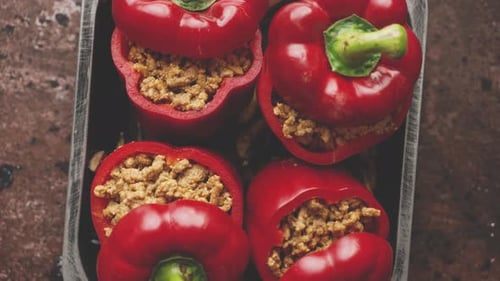 Fresh Stuffed Red Bell Peppers in Wooden Bowl