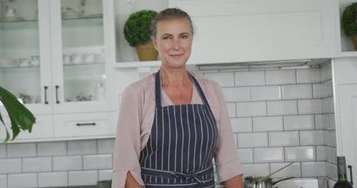 Woman Smiling in Bright Kitchen