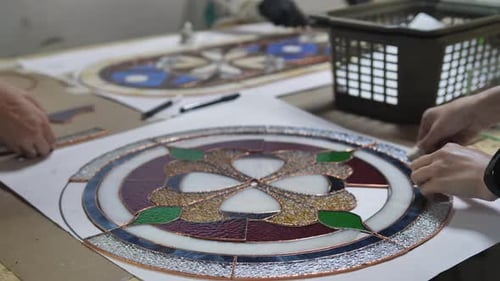 Artisans Assembling Colorful Stained Glass Flower Design