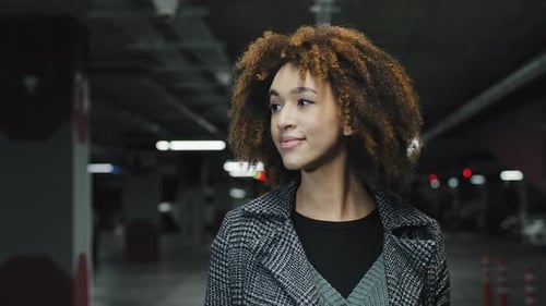Young Adult Female Standing in Parking Garage