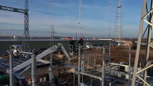 Electrical Workers Inspecting High Voltage Equipment