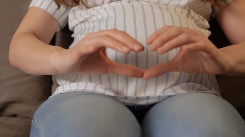 Pregnant Woman Makes Heart Shape on Baby Belly