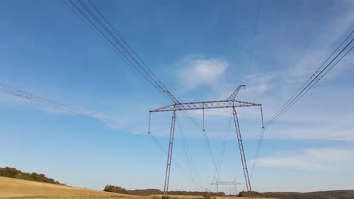 Electricity Pylons Stretching Across Rural Farmland