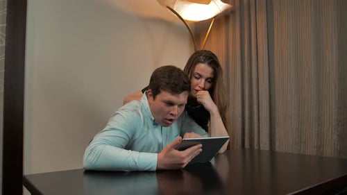 Couple Using Tablet Device Together at Home