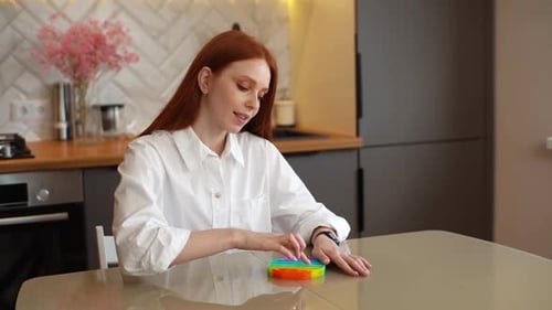 Woman Plays with Colorful Pop-It Fidget Toy