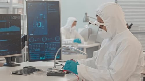 Engineer in Coveralls Working with Computer Elements in Laboratory
