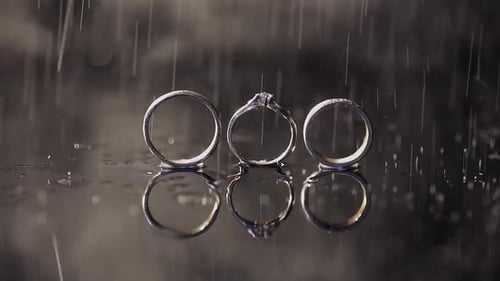 Three Wedding Rings with Water Falling On Them