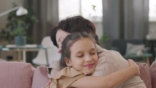 Loving Grandmother and Grandchild Embrace Affectionately at Home