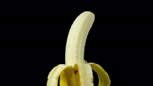 Rotating Close Up of a Partially Peeled Banana