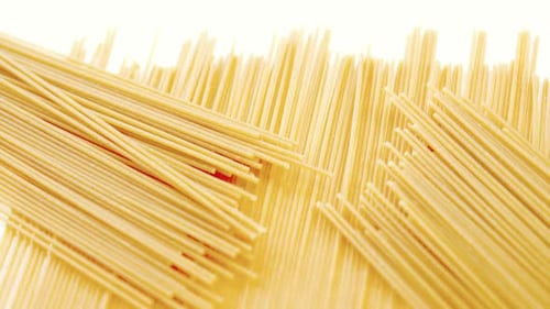 Golden Spaghetti Noodles on White Surface