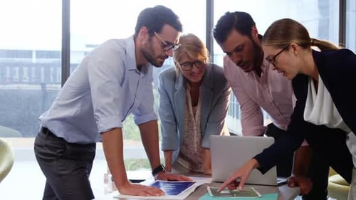 Business Team Collaborating on Project in Modern Office