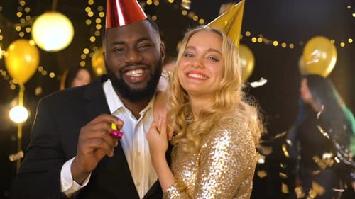 Positive Male and Female Friends Celebrating New Year Night Club, Blowing Horn